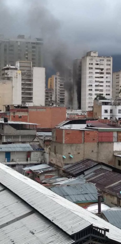 Caracas skyline with smoke from drone explosion.