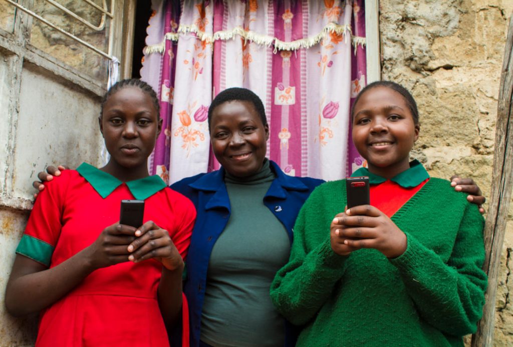 M-Shule learners with their parent. Photo by: M-Shule Communications team.
